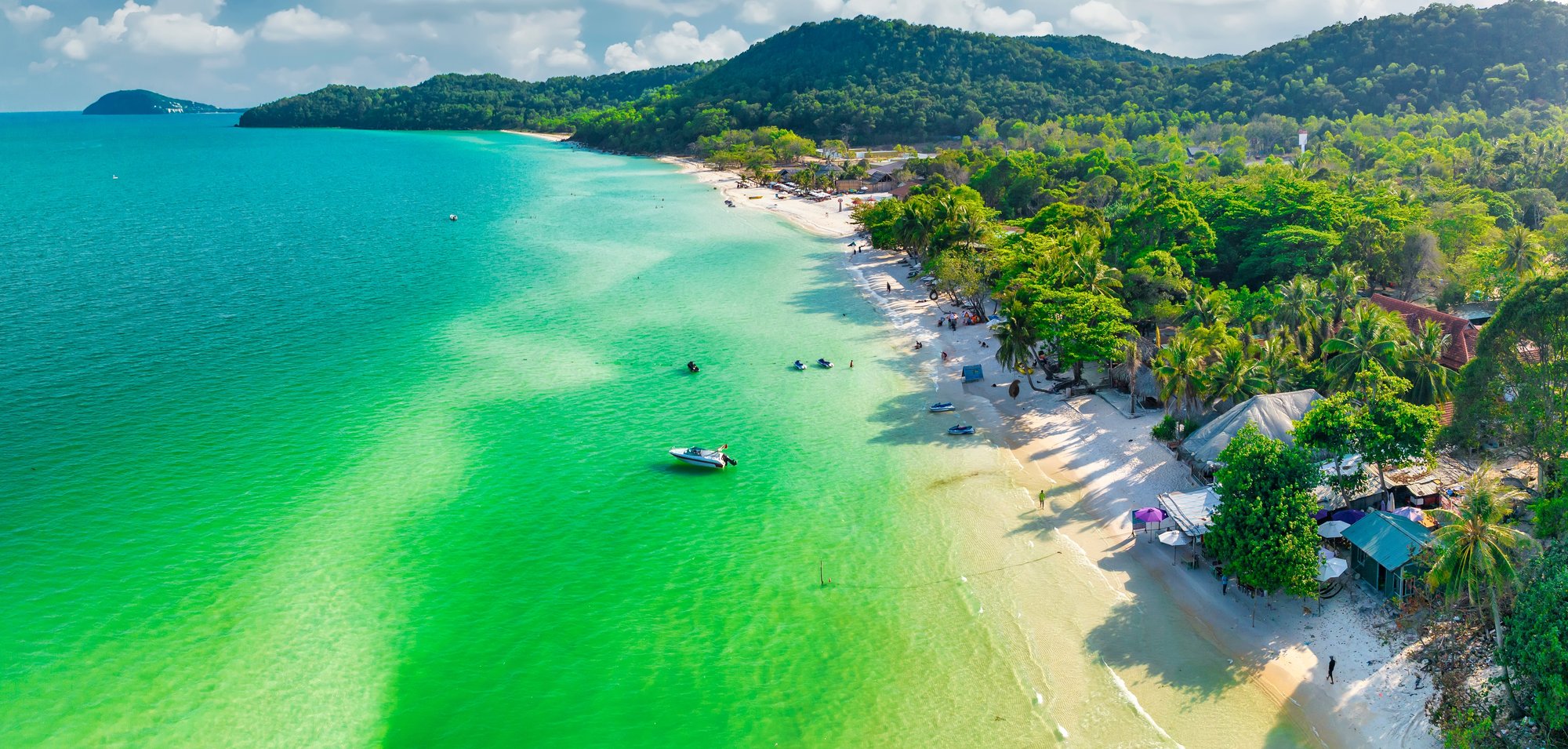 Aerial view of a tropical island resort coastline surrounded by turquoise water