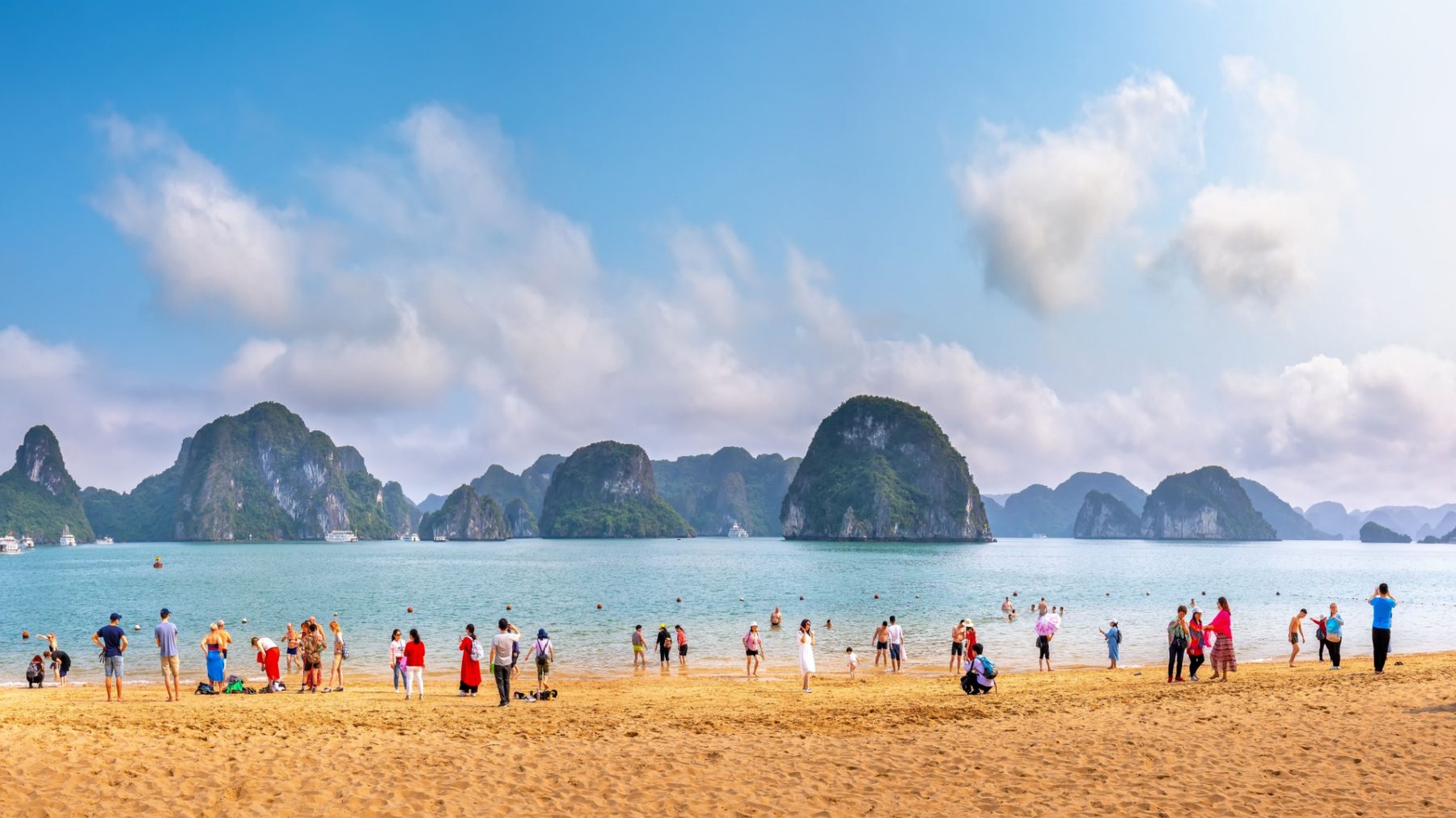 Tranquil Vietnamese beach at dusk with clear water and lush hillside, typical of the independent resort properties VAERIS serves